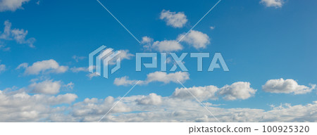 Panoramic view over blue deep sky with clouds as a background with copy space. 100925320