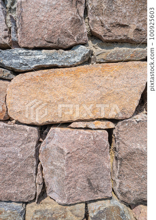 Pattern of ancient bricks and stones at old middle age fortress wall, as a background, closeup, details. 100925603