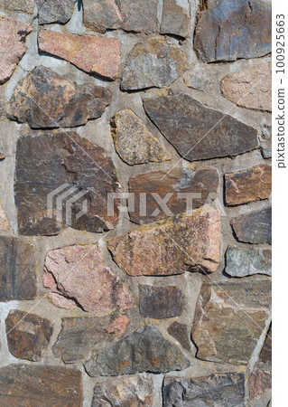 Pattern of ancient bricks and stones at old middle age wall, as a background, closeup, details. 100925663