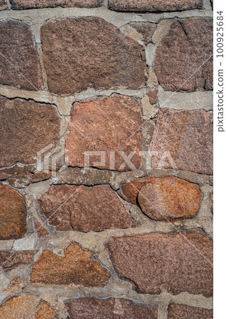 Pattern of ancient bricks and stones at old middle age wall, as a background, closeup, details. 100925684