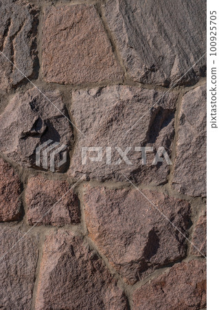 Pattern of ancient bricks and stones at old middle age wall, as a background, closeup, details. 100925705