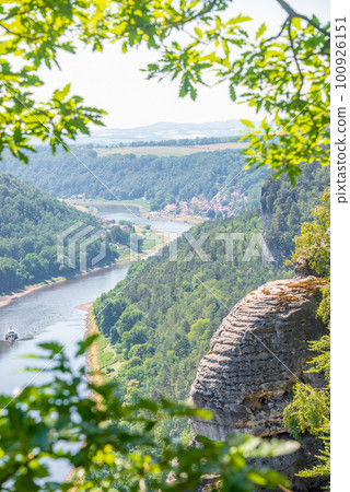 Cover page with birdview over monumental Bastei sandstone pillars near Kurort Rathen village in the national park Saxon Switzerland by Dresden and Elbe river, Saxony, Germany. 100926151