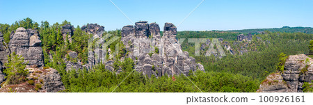 Panoramic view over monumental Bastei sandstone pillars and ancient bridge near Kurort Rathen village in the national park Saxon Switzerland by Dresden and Czechish border, Saxony, Germany. 100926161