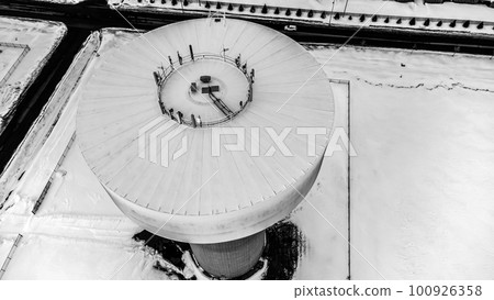 Drone overhead view of a water tower with communications antennae mounted on top  100926358