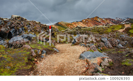 Icelandic landscape of colorful rainbow volcanic Landmannalaugar mountains, at Laugavegur hiking trail with dramatic sky, colorful rhyolite volcano soil and mossed lava fields in Iceland. 100926393