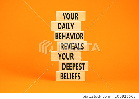 Behavior symbol. Concept words Your daily behavior reveals your deepest beliefs on wooden blocks. Beautiful orange table orange background. Copy space. Motivational business behavior concept. Behavior symbol. Concept words Your daily behavior reveals your deepest beliefs on wooden blocks. Beautiful orange table orange background. Copy space. Motivational business behavior concept. 100926503