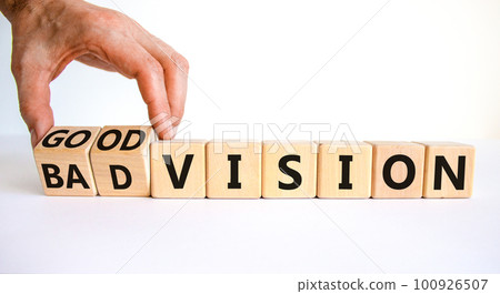 Good or bad vision symbol. Businessman turns cubes and changes words 'bad vision' to 'good vision'. Beautiful white table, white background, copy space. Business, good or bad vision concept. 100926507