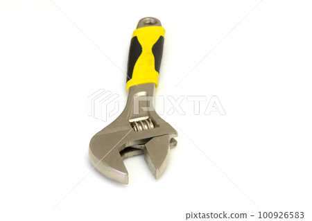 Adjustable metal old spanner on a white background. 100926583