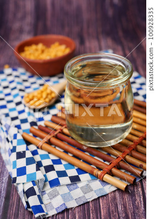 close up of Raw soy bean seed oil in a container close up of Raw soy bean seed oil in a container 100928335