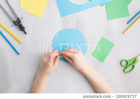 earth cut from paper around trees earth day concept kid's paper craft earth cut from paper around trees earth day concept kid's paper craft 100929737
