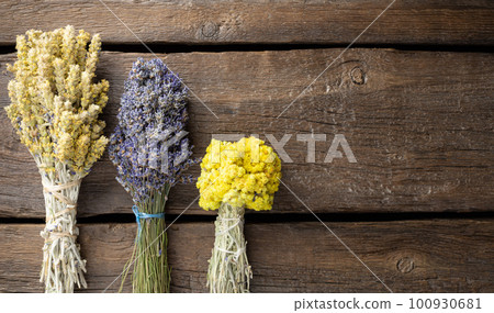 three different bunches of dried herbs on a dark wooden background. Herbal medicine. flat lay. copy space. three different bunches of dried herbs on a dark wooden background. Herbal medicine. flat lay. copy space. 100930681