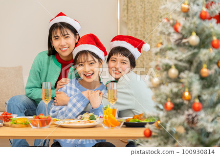 A young woman having a Christmas party 100930814