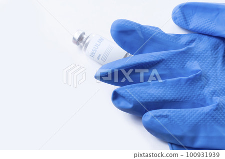 Insulin ampoule and medical gloves isolated against white background. 100931939
