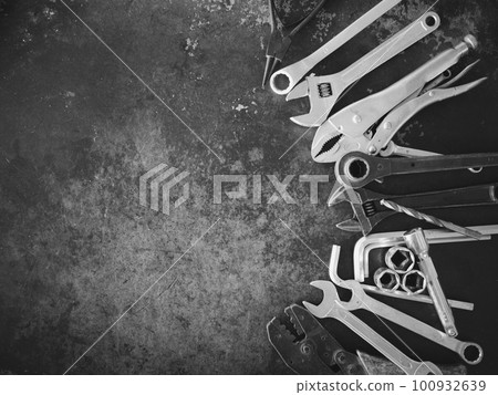 Hand tools consisting of wrenches, pliers, socket wrenches, laid out on old steel plate background. Hand tools consisting of wrenches, pliers, socket wrenches, laid out on old steel plate background. 100932639