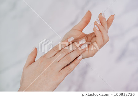 Female hands with french manicure on nails. Soft skin, skincare, beauty Female hands with french manicure on nails. Soft skin, skincare, beauty 100932726