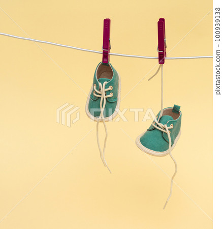 Baby shoes hanging on the clothesline. Newborn concept 100939138