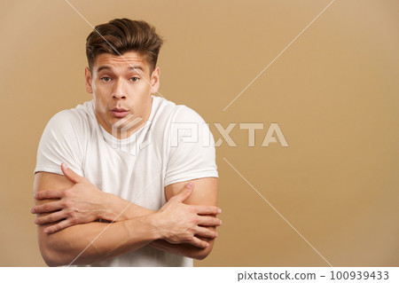 Man looking at camera woman gesturing he is cold 100939433