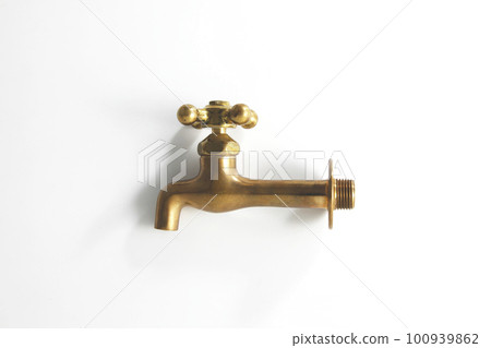 A nostalgic old-fashioned brass faucet shot with a white background A nostalgic old-fashioned brass faucet shot with a white background 100939862