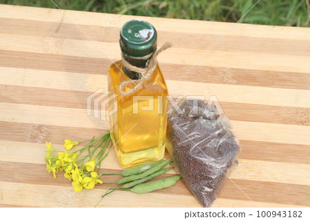 mustard oil with seed flower and money bag on farm for harvest are cash crops mustard oil with seed flower and money bag on farm for harvest are cash crops 100943182