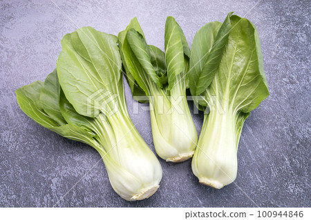 Fresh Organic Pak Choi, Bok Choy, a Chinese Cabbage, Raw Natural Healthy Vegetable Lying On Gray Granite Table, Flat Lay, Top View. Asian Cuisine. Horizontal plane. 100944846