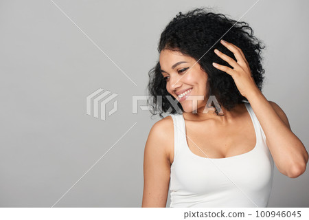 Happy smiling mixed race girl looking to side at blank copy space 100946045