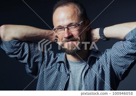 Man in glasses looking at camera with mistrust expression 100946058