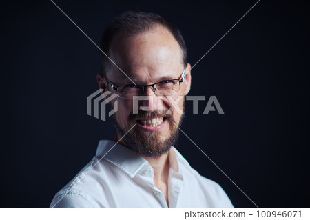 Closeup roaring middle age man in white shirt and eyeglasses looking squinting at camera Closeup roaring middle age man in white shirt and eyeglasses looking squinting at camera 100946071