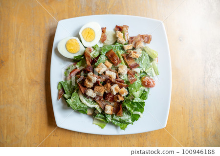 Caesar salad with boiled eggs, healthy food style Caesar salad with boiled eggs, healthy food style 100946188