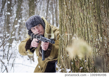 Soviet soldier in the winter forest. Retro photo 100946496