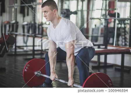 athlete doing deadlift n style sumo in gym athlete doing deadlift n style sumo in gym 100946894