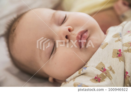 close-up face of a beautiful sleeping baby 100946922