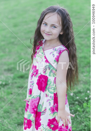 Pretty Girl in a colorful dress in the field 100946949