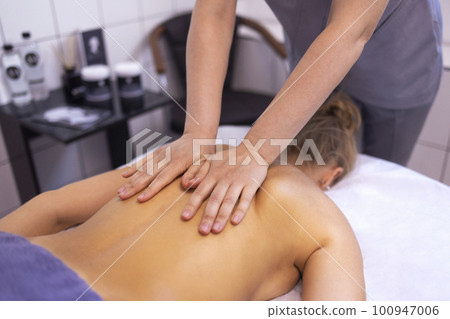 Caucasian woman getting a back massage in the spa salon Stock