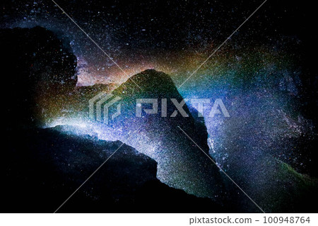 A rock surrounded by a rainbow at the basin of a waterfall A rock surrounded by a rainbow at the basin of a waterfall 100948764