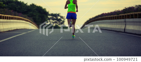 Young fitness asian woman runner running on city road 100949721