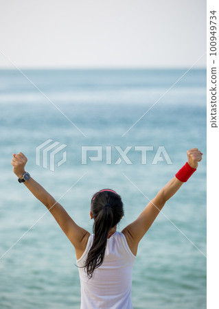 Young successful woman open arms at seaside Young successful woman open arms at seaside 100949734