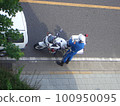 A police motorcycle policeman filling out a ticket for cracking down on traffic violations 100950095