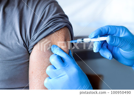 Elderly Man in Face Mask getting Covid Vaccine. Doctor giving Injection to senior Man at Hospital. Virus, COVID-2019, Flu protection. Vaccination of old Patient in Clinic during Coronavirus pandemic. Elderly Man in Face Mask getting Covid Vaccine. Doctor giving Injection to senior Man at Hospital. Virus, COVID-2019, Flu protection. Vaccination of old Patient in Clinic during Coronavirus pandemic. 100950490