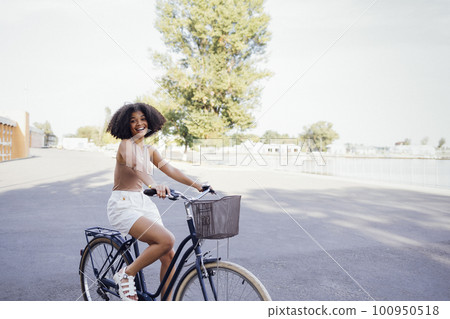 Young and positive afro american girl in casual cloth smiles sweetly and has a fun 100950518