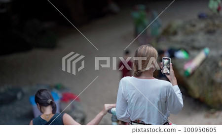 girl filming the beach on the phone girl filming the beach on the phone 100950605