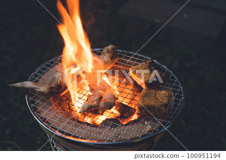 For dinner, grilled meat on a charcoal grill For dinner, grilled meat on a charcoal grill 100951194