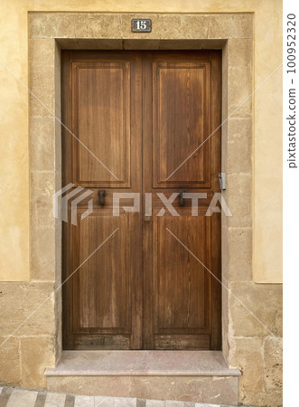 Wooden door in stone wall in Mallorca, Spain Wooden door in stone wall in Mallorca, Spain 100952320
