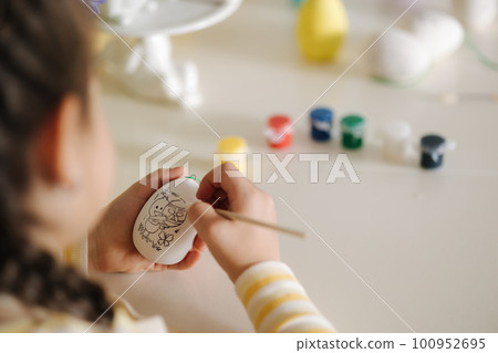 First person view of little girl painting easter egg First person view of little girl painting easter egg 100952695