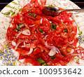 Tasty homemade tomatoes salad in white bowl. 100953642