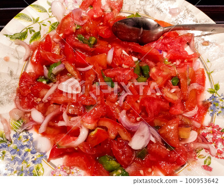 Tasty homemade tomatoes salad in white bowl. Tasty homemade tomatoes salad in white bowl. 100953642