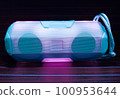 Portable wireless speaker with wooden Background. 100953644