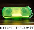 Portable wireless speaker with wooden Background. 100953645