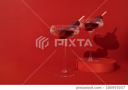 Two glasses of champagne and fruit ice cream on the podium. Two glasses of champagne and fruit ice cream on the podium. 100955037