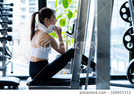 Young woman training in a sports gym Young woman training in a sports gym 100955153