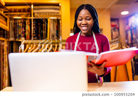 authentic ethnic africa america sellerwoman working in shop with laptop authentic ethnic africa america sellerwoman working in shop with laptop 100955204